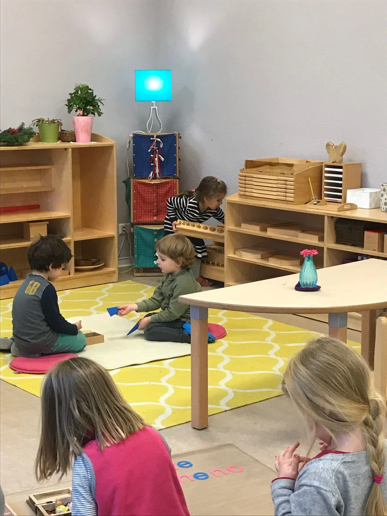 A prepared environment with Children at work on mats